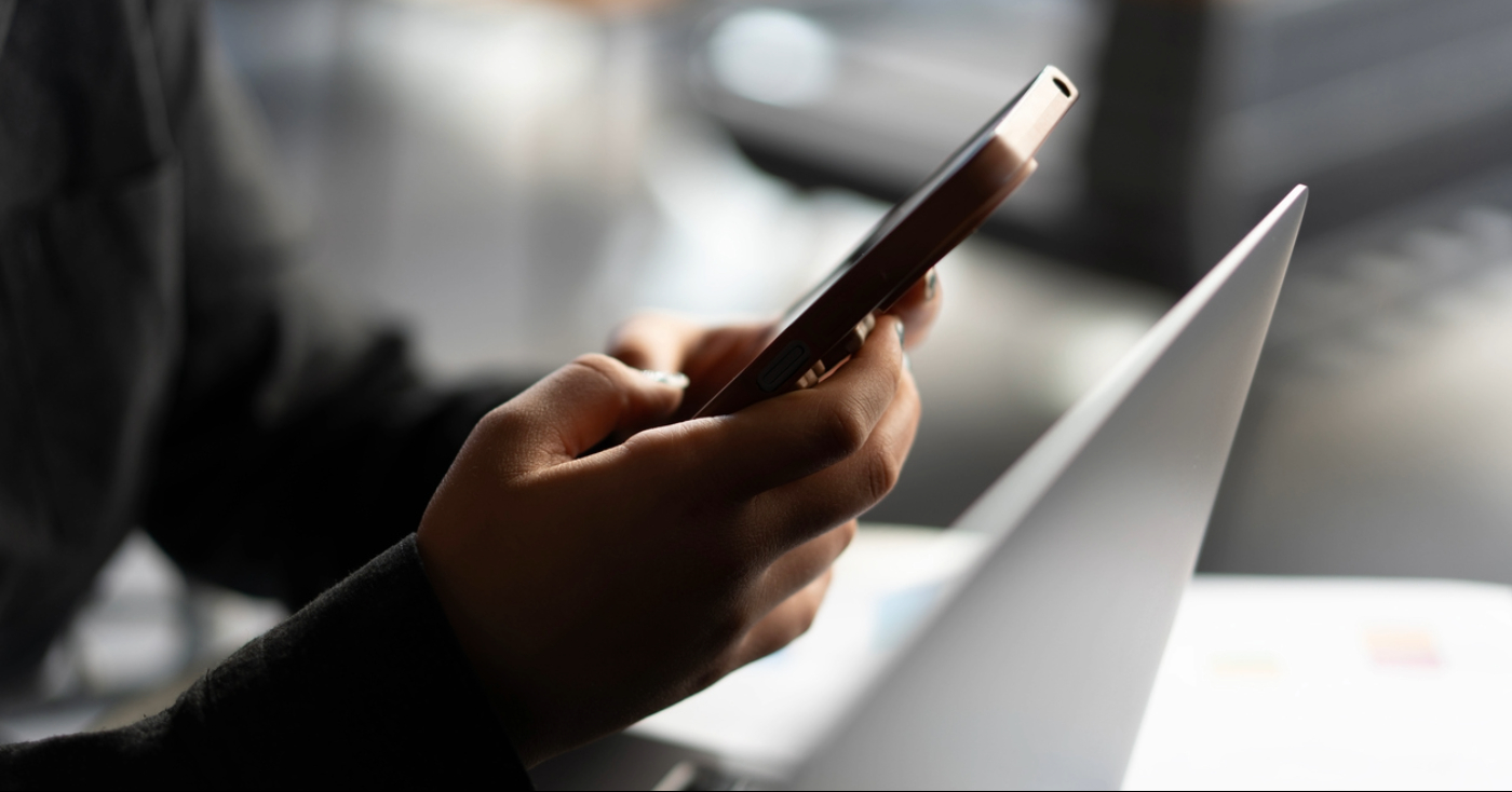 Cropped-image of person using their smartphone.
