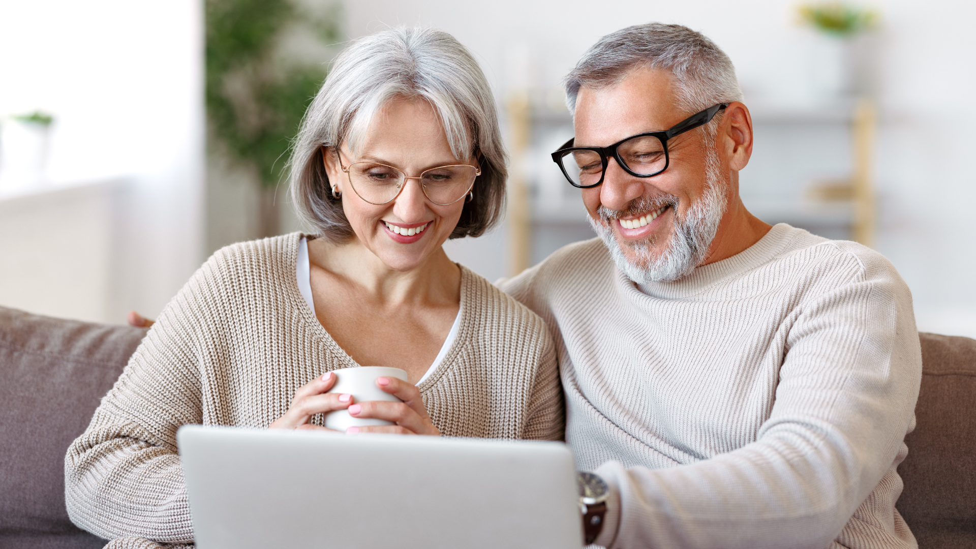 Older couple using patient engagement software to review their medical bill online together