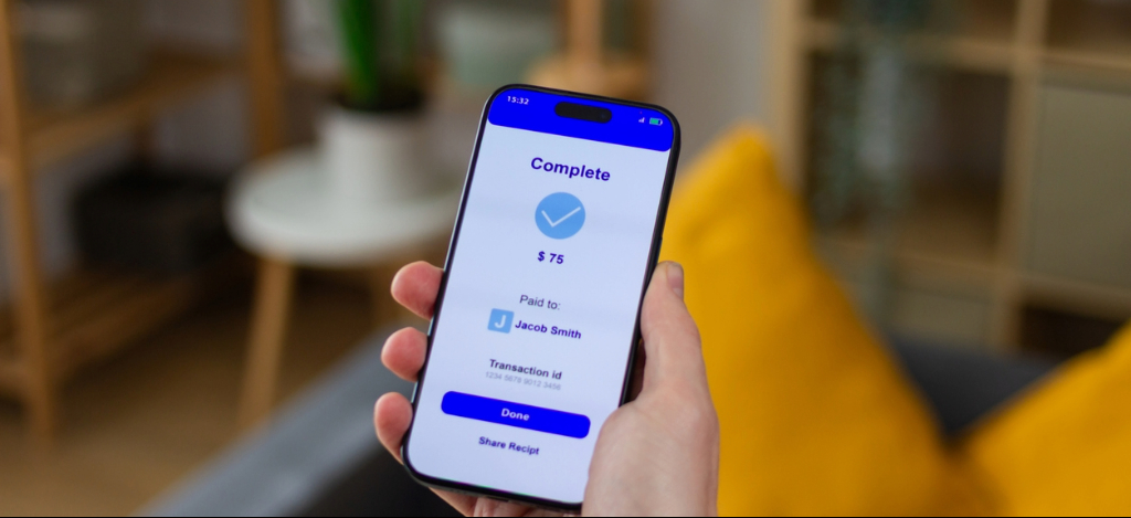 Hand with smartphone shows successful mobile payment confirmation screen.
