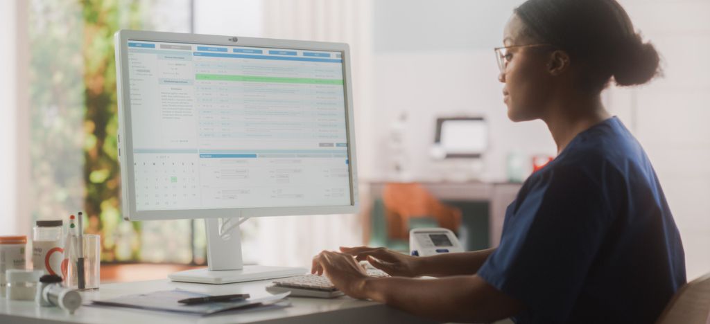 Patient Payment Experience: healthcare staff member managing patient billing and payments on a desktop.