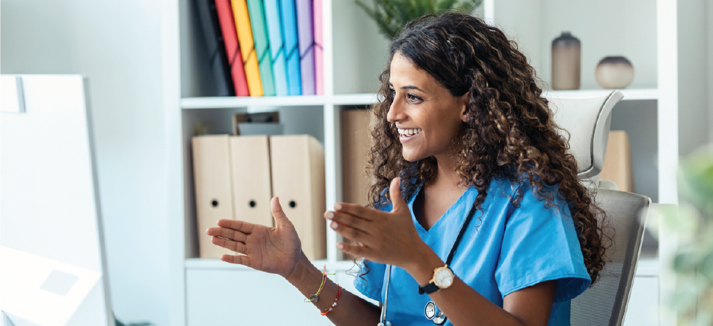 Female doctor speaking with her patient virtually using a computer.