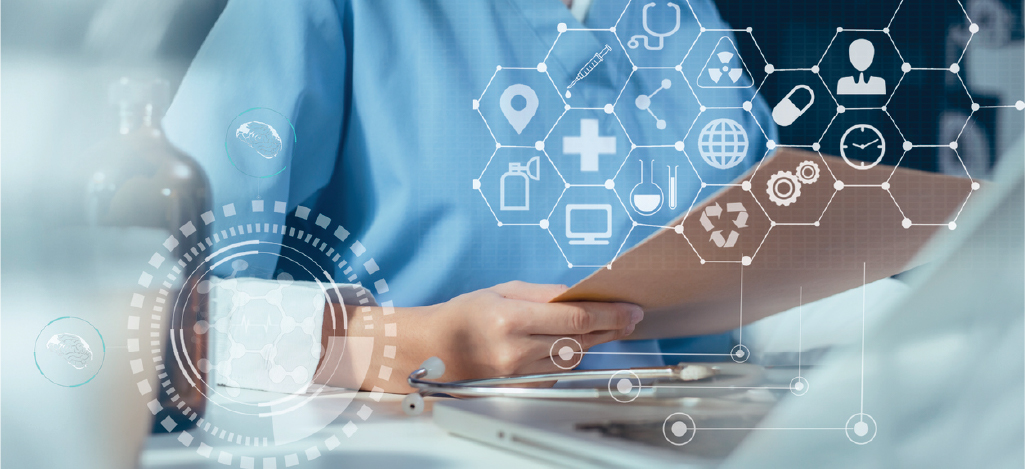  A doctor using a laptop while reviewing patient data and other medical information.