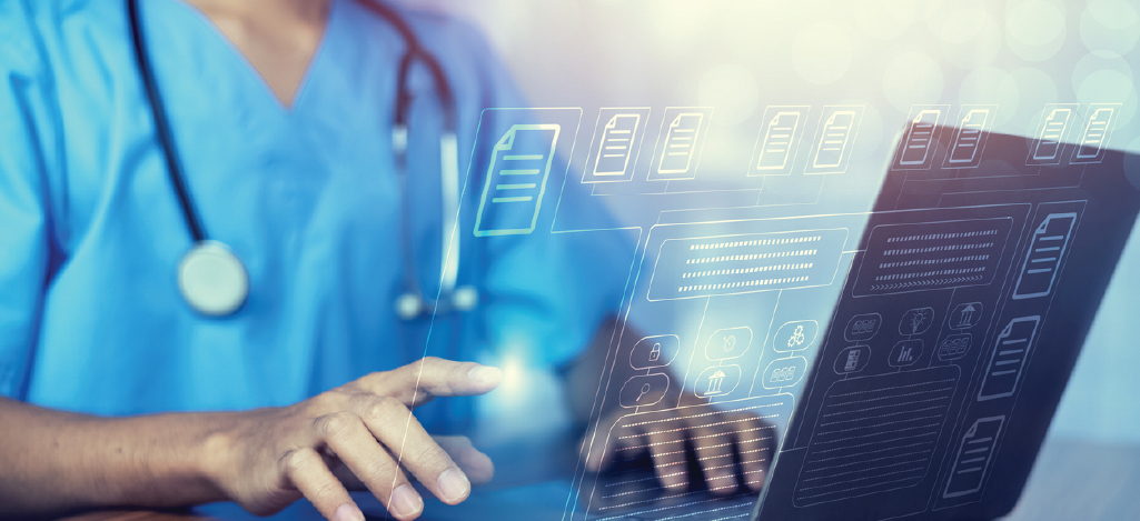 A male doctor using a laptop to backup patient data and other medical information.