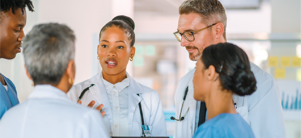 A team of medical professionals having a discussion in a hospital setting.