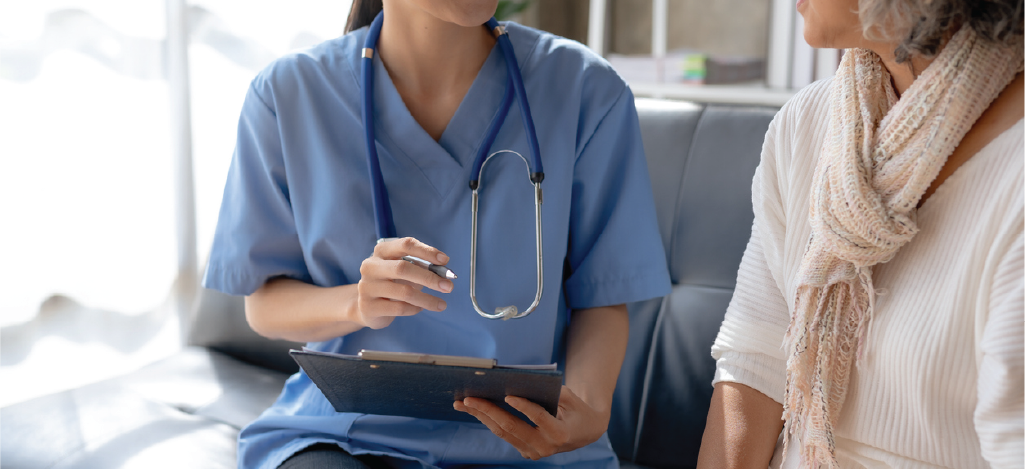 Clean claims processes - Female doctor interviewing a female senior patient for accurate claims submission.