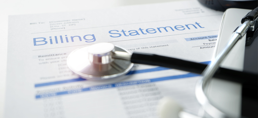 Close-up shot of the medical billing statement placed on a white table with a stethoscope on top of it.