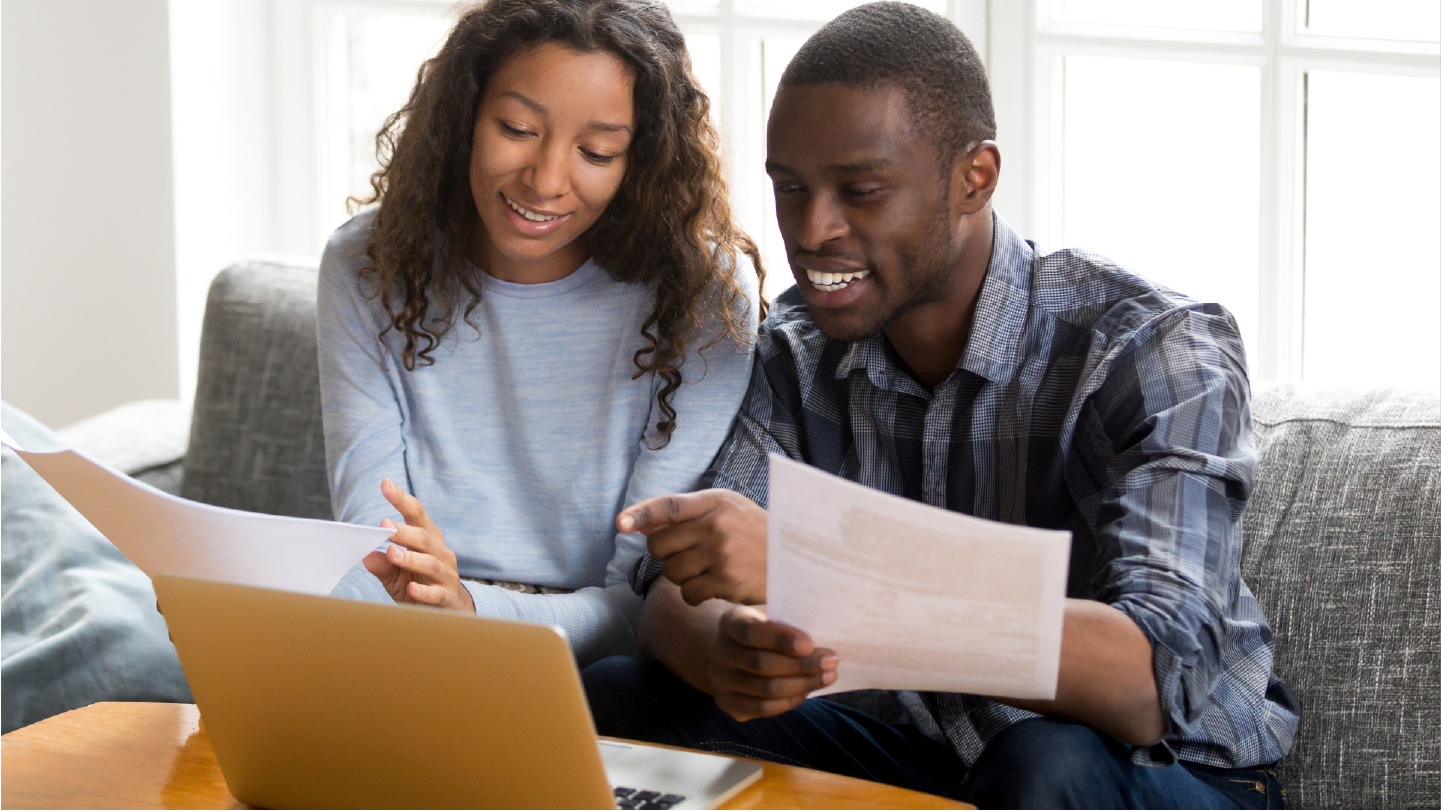 A couple looking at their paper bill