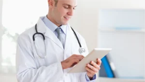 Doctor looking at a table reviewing the practice's Revenue Cycle Management