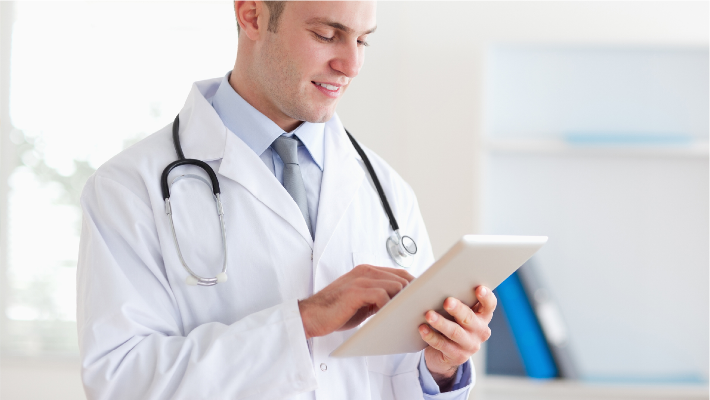 Doctor looking at a table reviewing the practice's Revenue Cycle Management