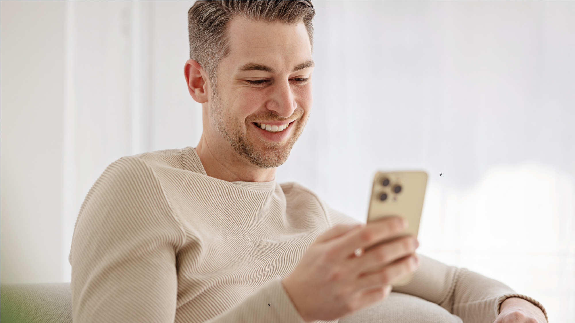 A man looking at his phone participating in secure patient messaging with his provider