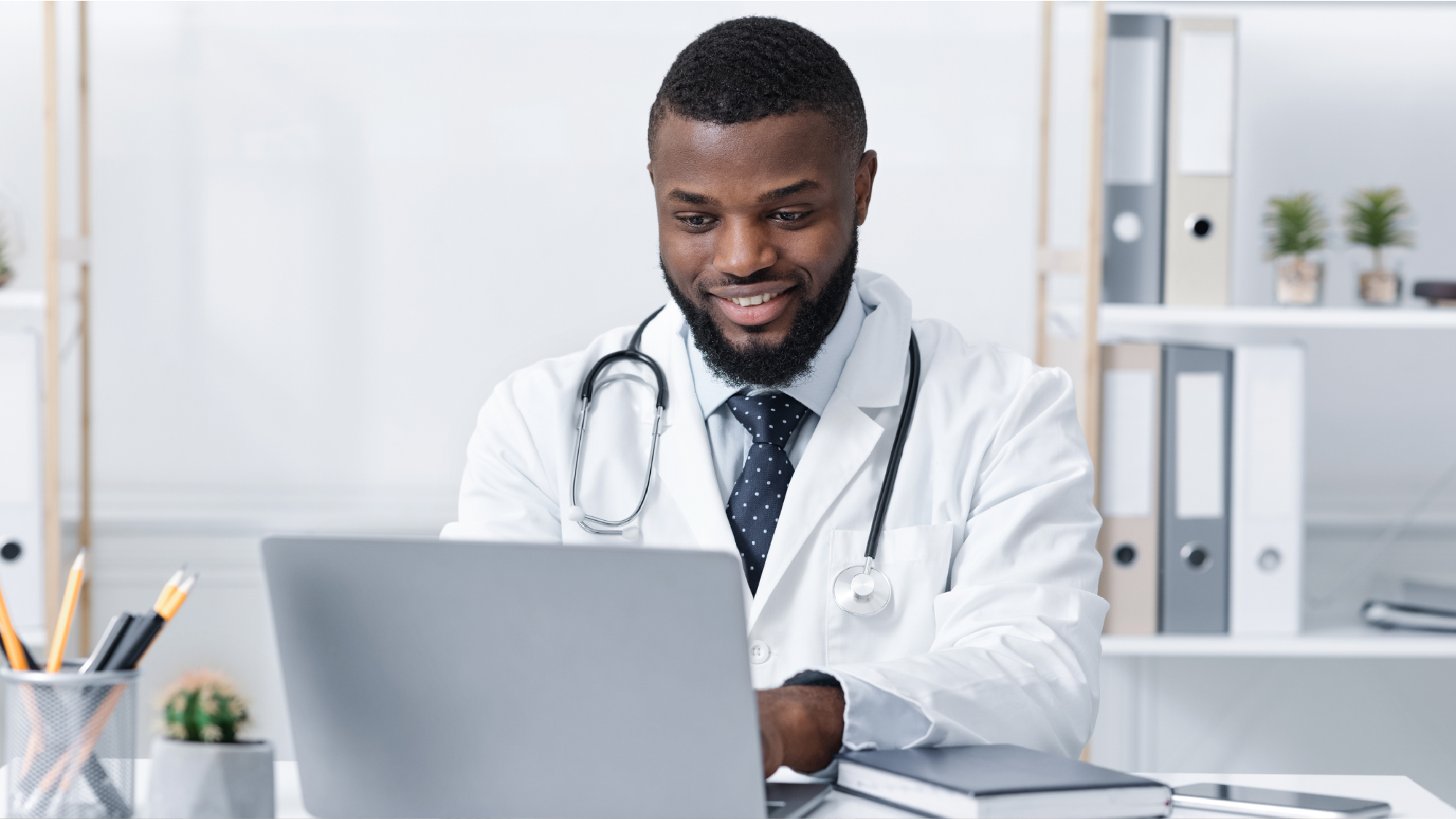 Doctor using medical practice management system on a computer in a medical office