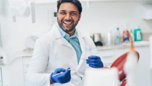 A dentist holding dental equipment