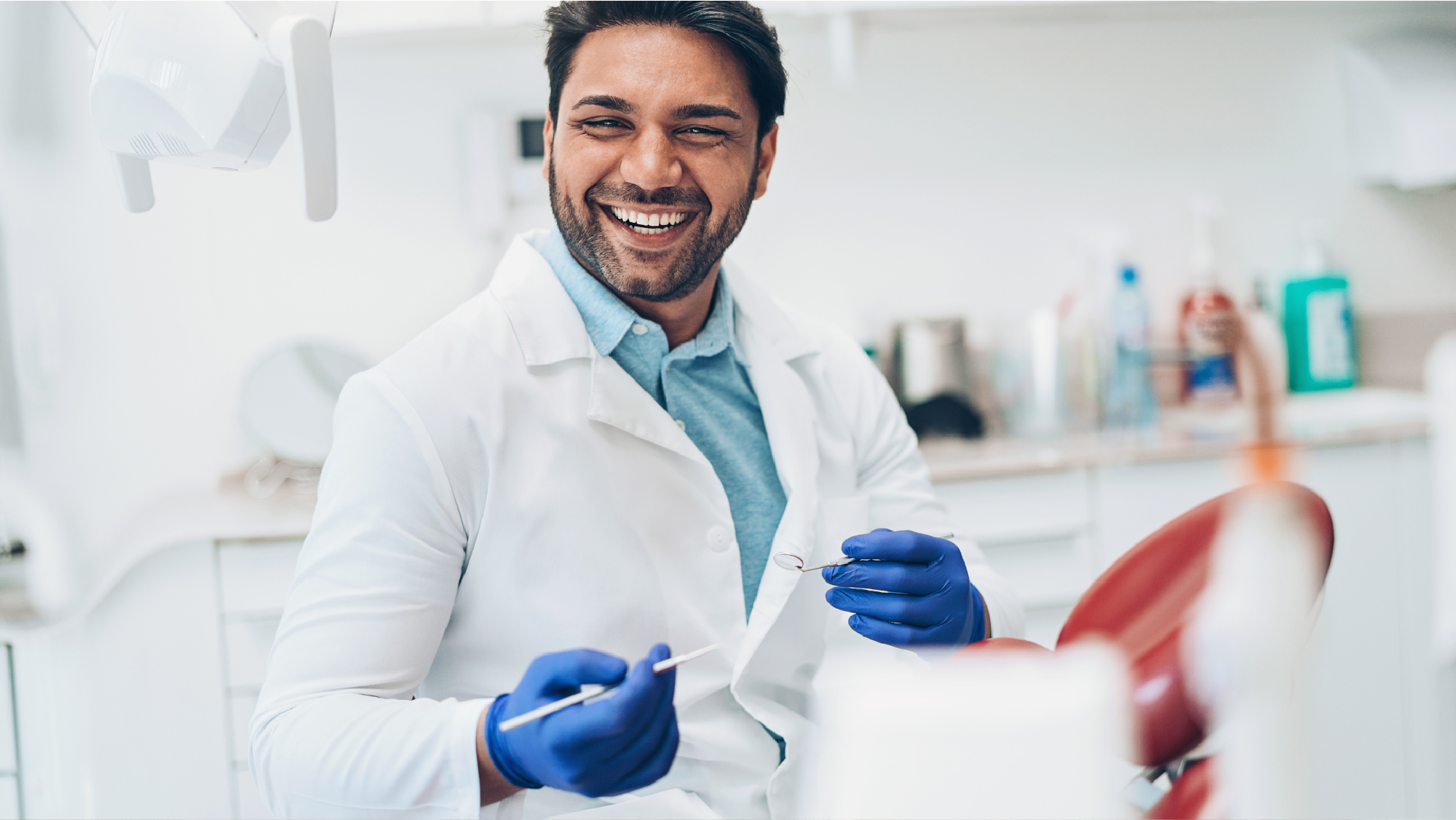 A dentist holding dental equipment