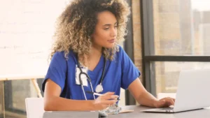 Woman using Health Information Exchange Software at a medical practice