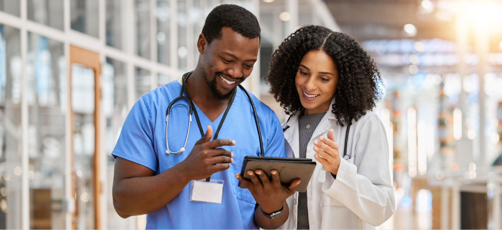 RCM company - Two doctors looking at their practice’s RCM software through a tablet device.