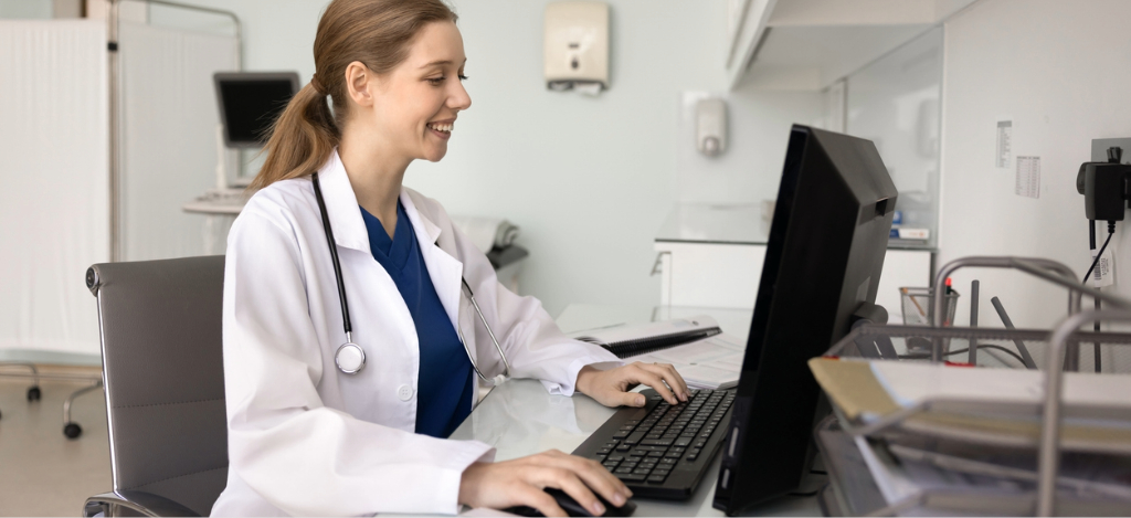 Best RPA software - A female doctor in an office using a computer.