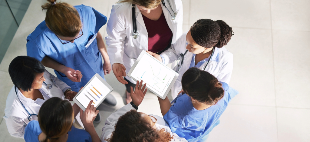 End-to-end RCM software - A group of doctors holding tablet devices showing their practice’s medical billing software.