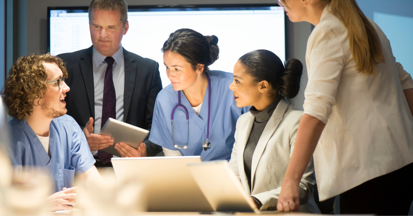 Revenue cycle management companies - A group of healthcare professionals having a meeting with their business partners about RCM services.