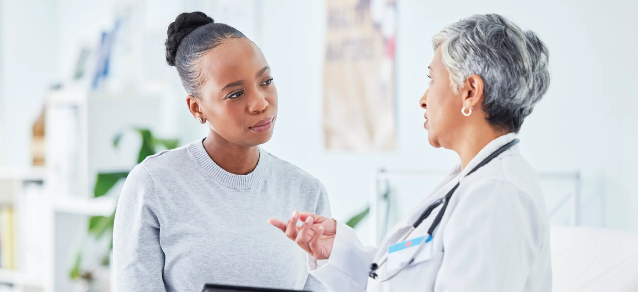 Patient payment options - A female doctor explaining payment options to a female patient.
