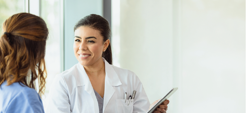 Improving revenue cycle - A female doctor discussing medical billing with her female patient.