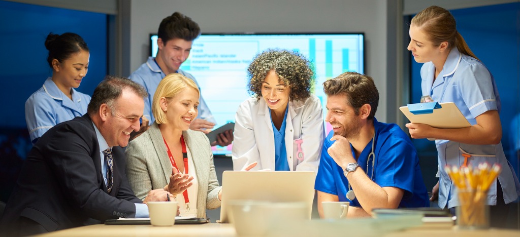 Pre-visit billing for improved revenue cycle - A team of billing providers and healthcare professionals discussing practice revenue.