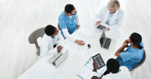 What is practice management software - A team of doctors discussing their practice’s overall operations.