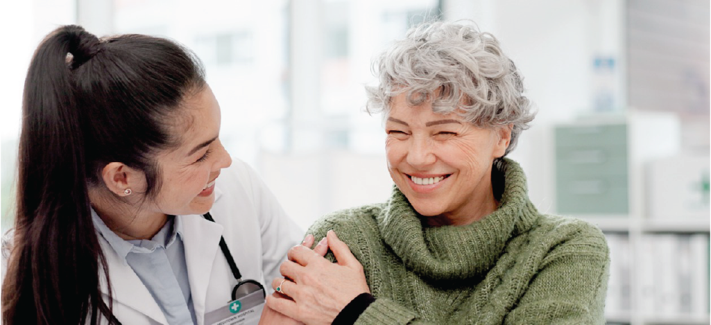 Offering financing for medical procedures - A female doctor assisting a female senior patient in a hospital.