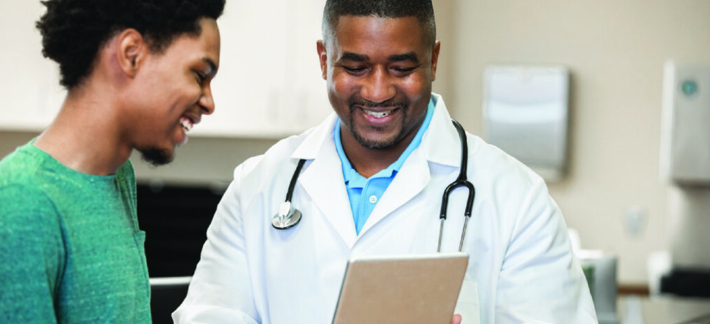 Choosing the best medical billing software for patient experience - A male doctor using a tablet device to explain medical billing to his male patient.