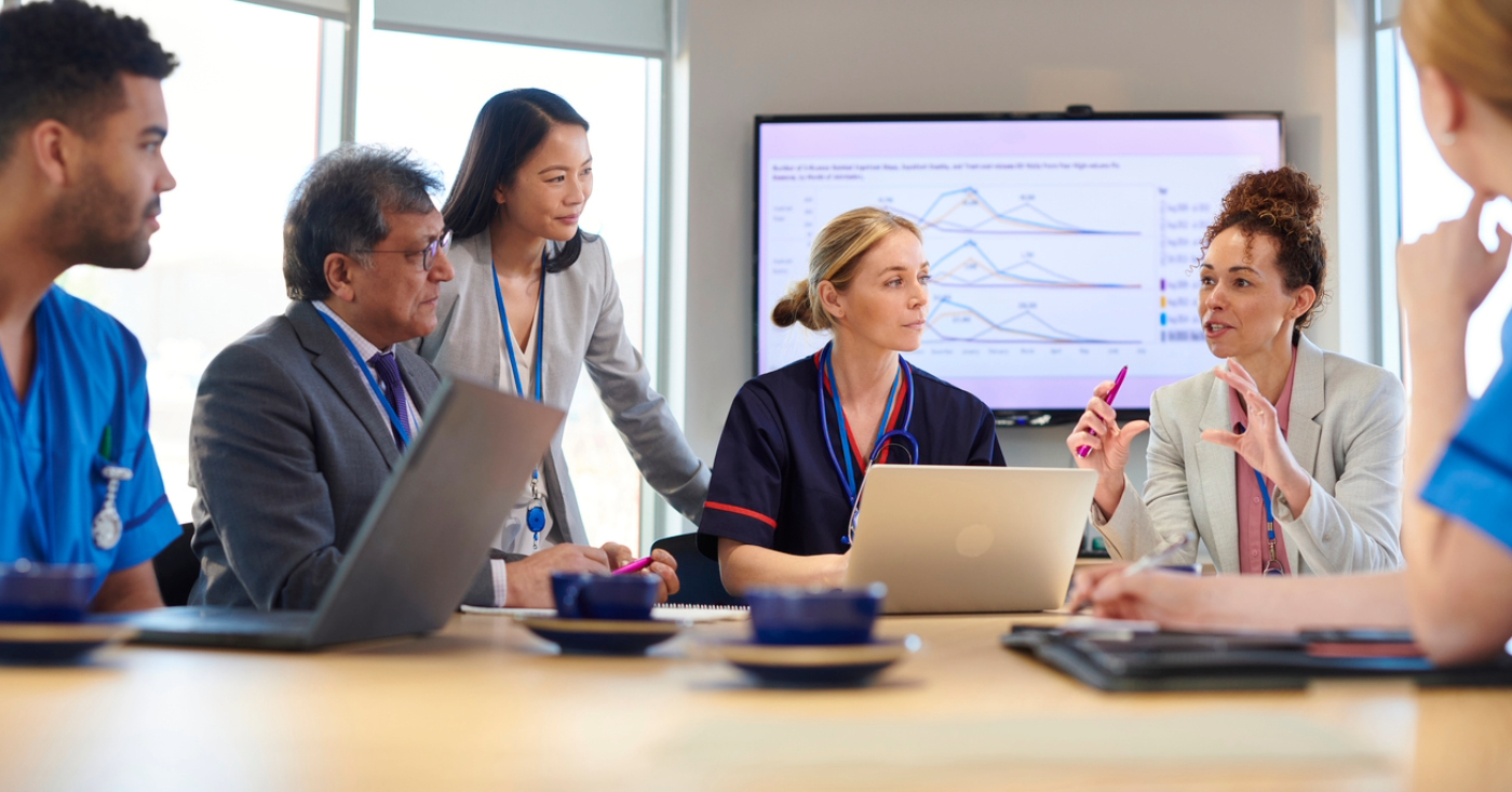 End-to-end RCM software - A group of medical professionals and business owners having a meeting about improving patient collections.