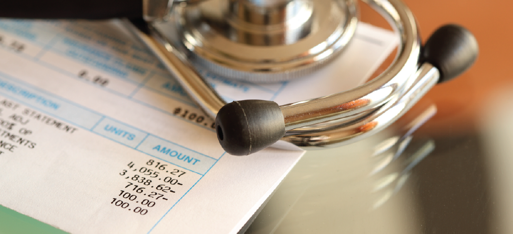 A doctor’s stethoscope on top of a patient’s medical bill - preventing medical billing errors.