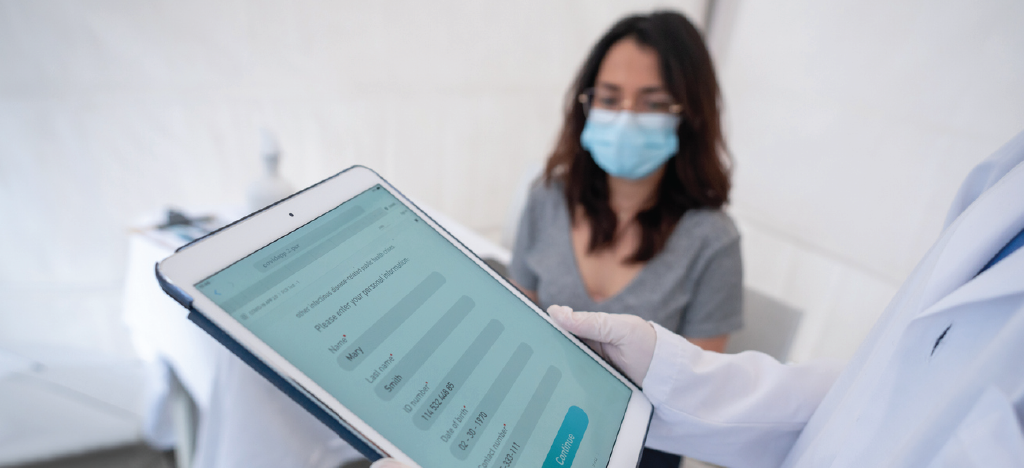 Preventing claim errors - A doctor filling out a patient form using a tablet device.
