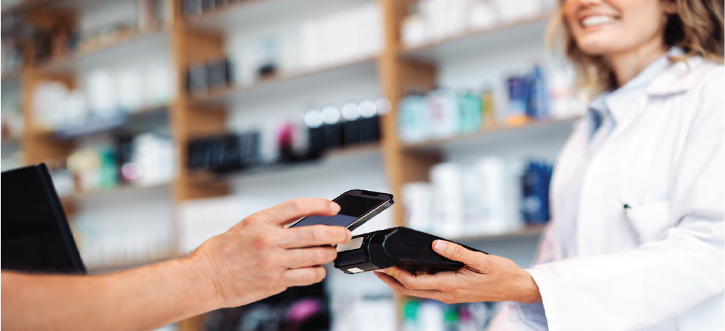 Female doctor holding an EMV terminal for accepting patient payments - effective payment processing system.