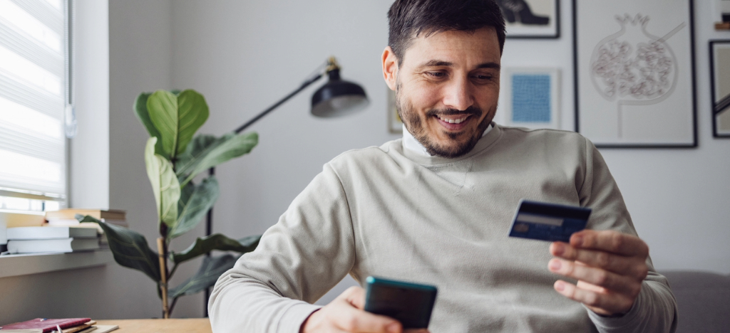 EBPP for practices - A man at home using his credit card to pay for his medical bill online.