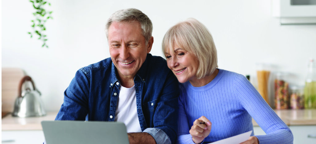 Using eBill and mailed medical statements - A senior couple comparing their mailed medical statements with an emailed medical bill.