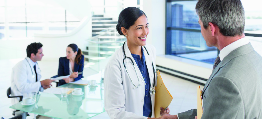 Finding patient statement service provider - A female doctor shaking hands with a businessman during a meeting.