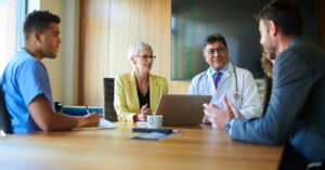 RCM company - A group of doctors and business owners having a meeting in a conference room.