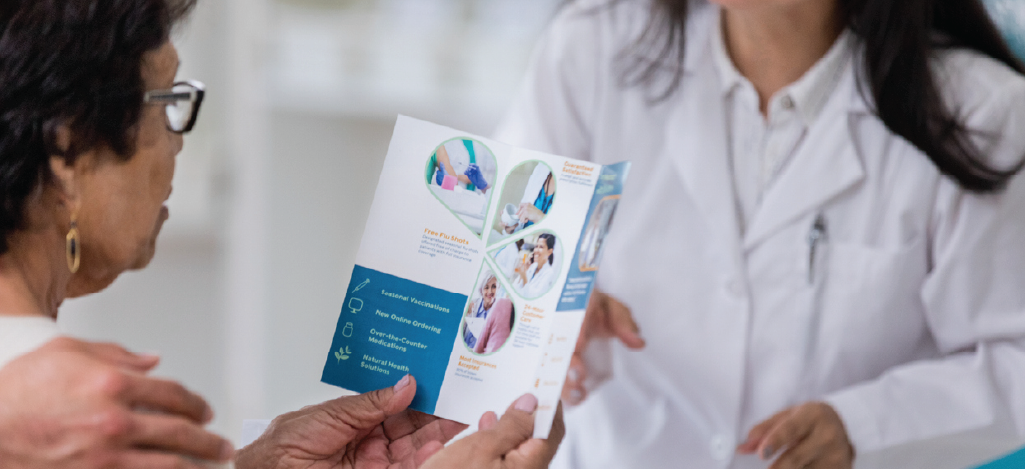 Patient statement inserts - A senior woman holding a leaflet during a medical appointment.
