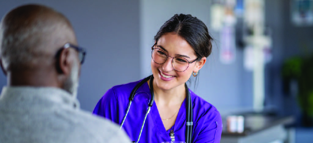 Improving patient experience - A female doctor assisting a senior male patient in a clinic.