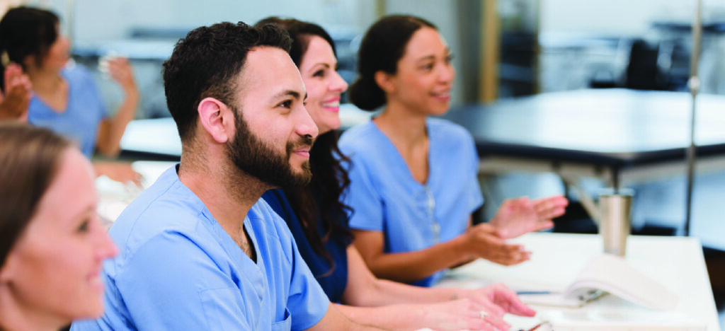 Tackling healthcare burnout - A group of healthcare workers listening during training.