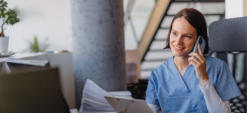 Telehealth billing for medical practices - A female medical professional talking to a patient over the phone.