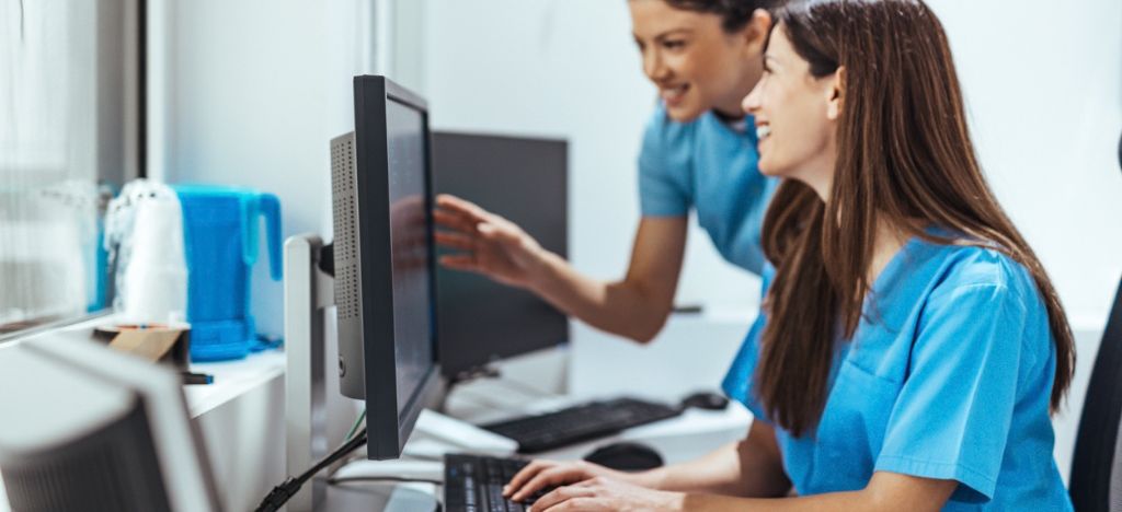 Healthcare professionals checking desktop together.