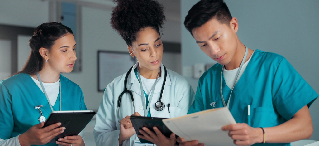 Medical billing issues - A team of medical professionals using tablet devices to review patient bills.
