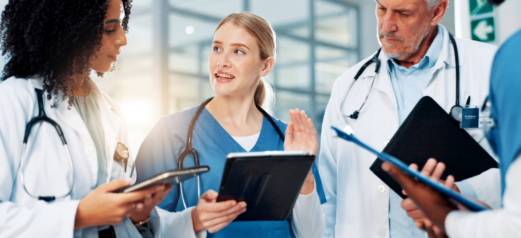 EBPP - A team of doctors using tablet devices while discussing billing and payment processes.